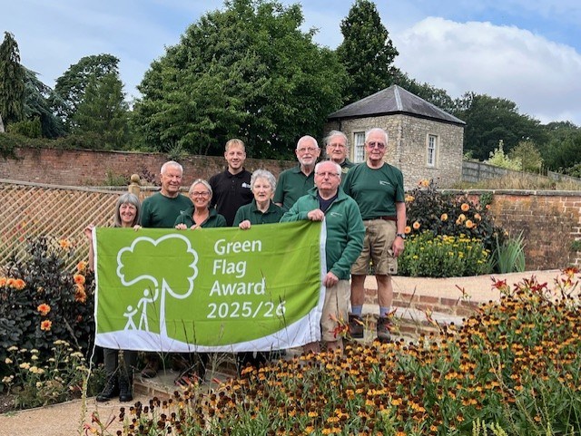 People standing by the Green Flag for Cusworth Park